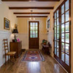 Double door Entry With Wood Floors And Beamed Ceiling Http www